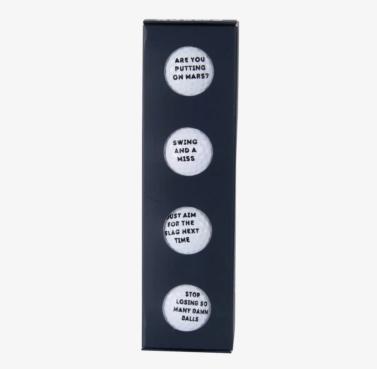 Set of four golf balls with humorous sayings on a black box