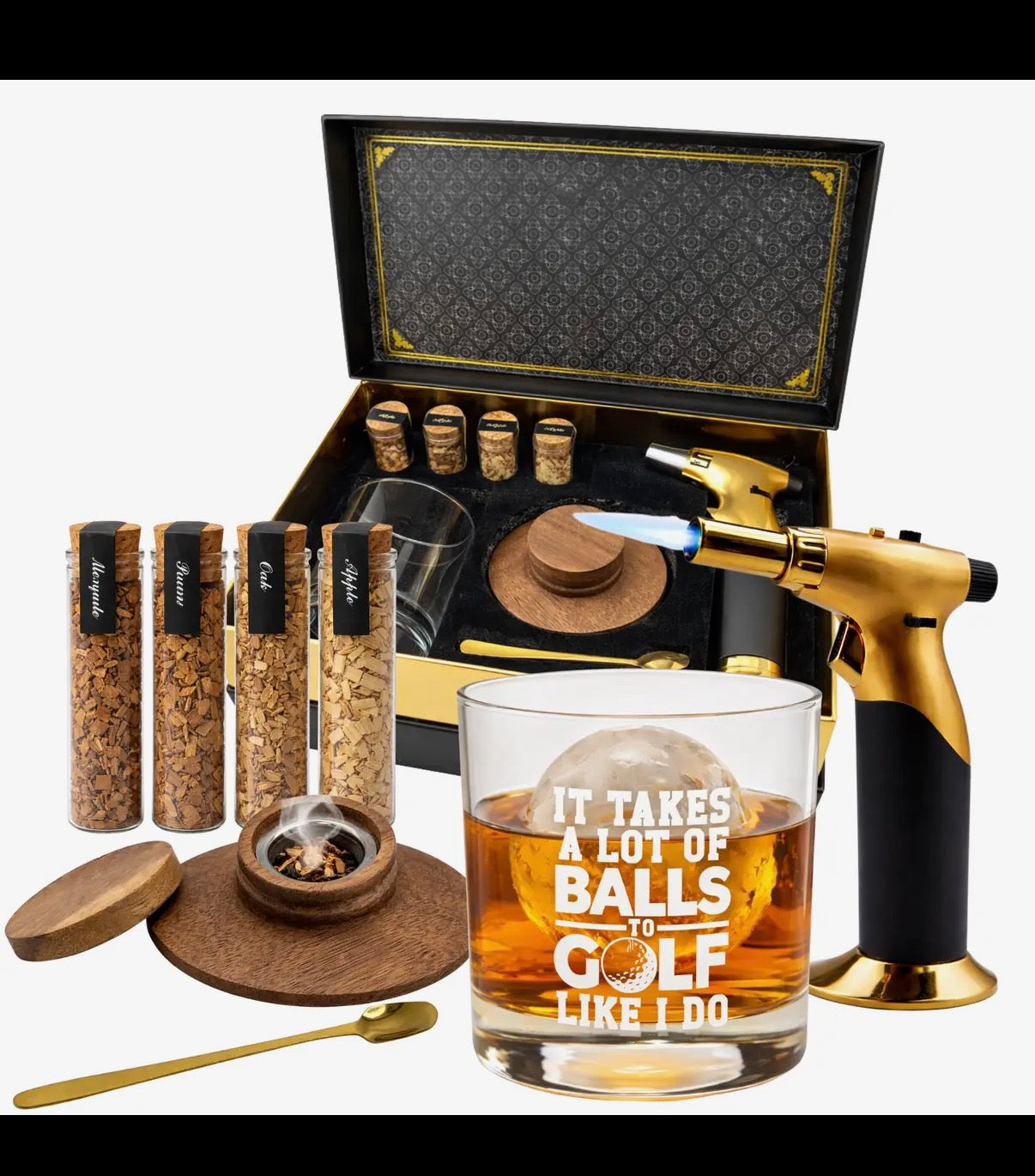 Gifting set with a glass, lighter, and various items in an open black box.