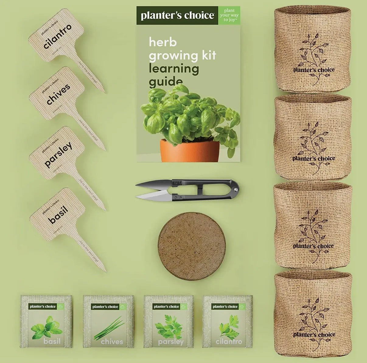 Herb growing kit with pots, labels, and guide on a green background